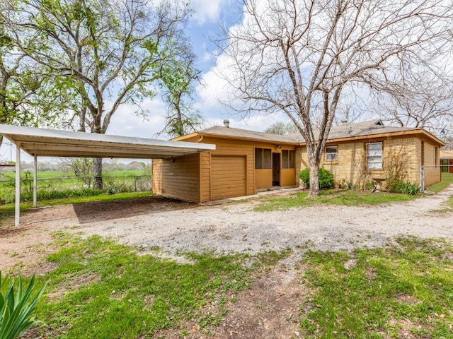 view of front of house with a garage and a carport