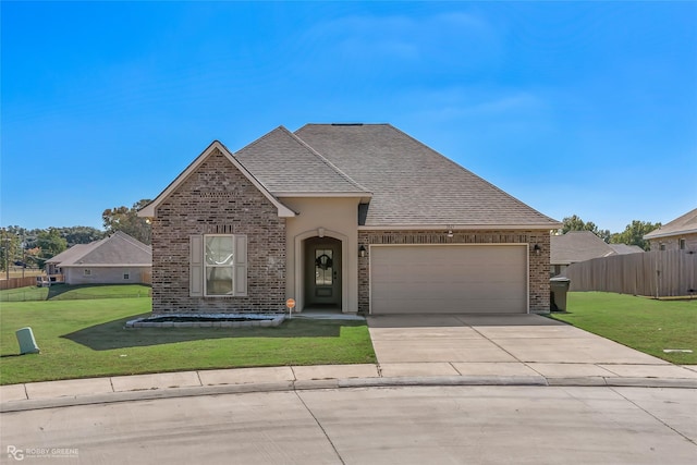 view of front of home featuring a garage and a front yard