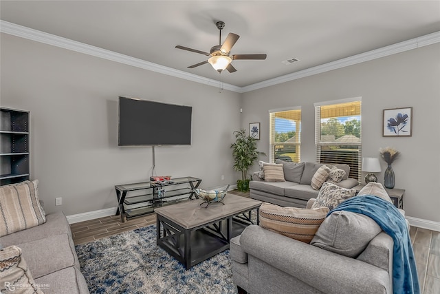 living room with ceiling fan and ornamental molding