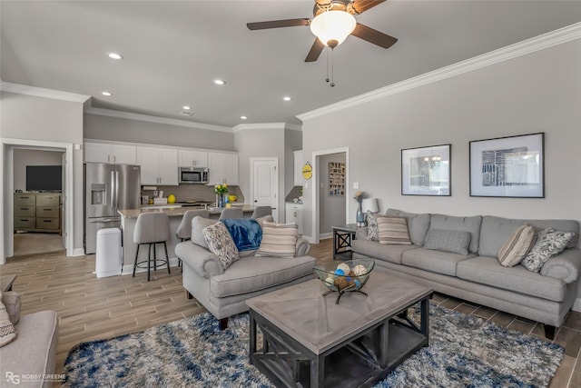 living room featuring crown molding and ceiling fan