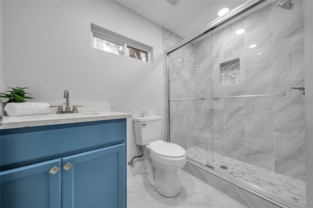 bathroom with vanity, toilet, and walk in shower