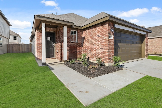 view of front of property featuring a garage and a front lawn