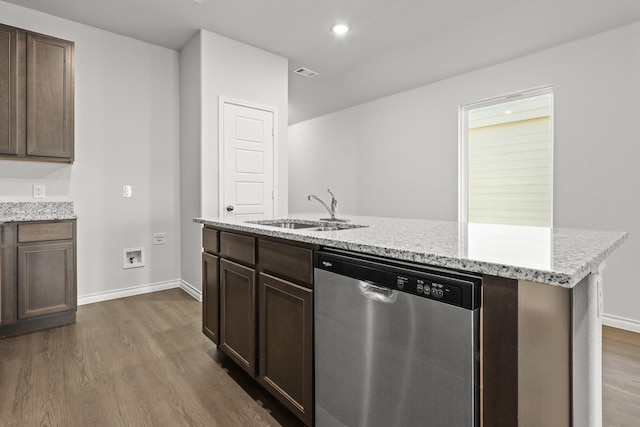 kitchen with dishwasher, sink, a kitchen island with sink, dark brown cabinetry, and dark wood-type flooring