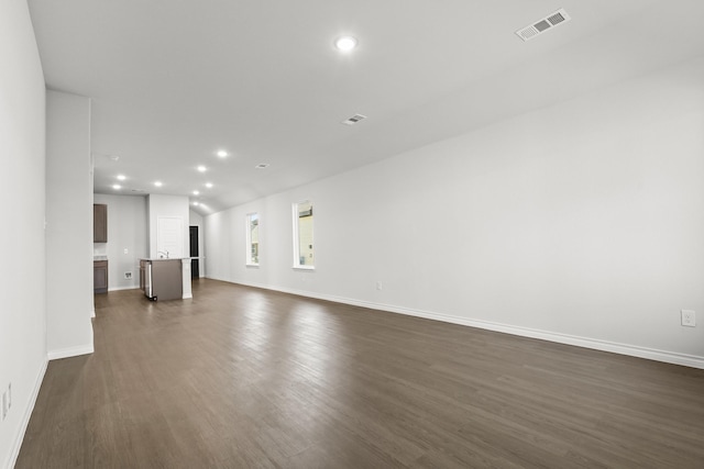 unfurnished living room featuring dark hardwood / wood-style floors