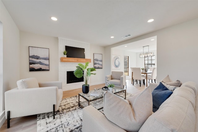 living room featuring hardwood / wood-style flooring and a fireplace