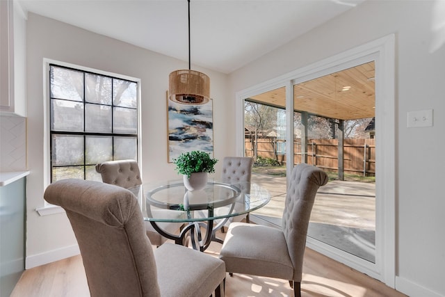 dining area with light hardwood / wood-style flooring and a wealth of natural light