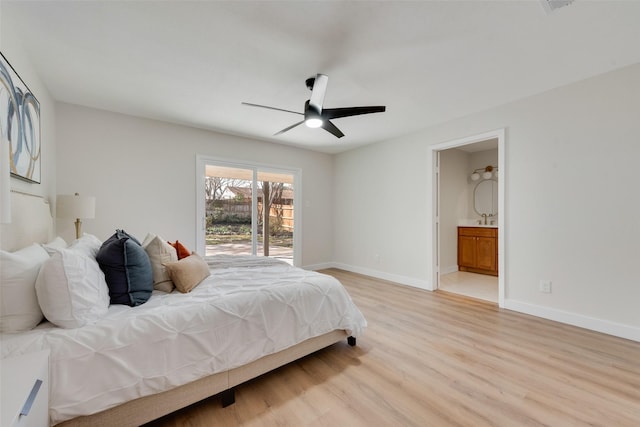 bedroom with sink, access to outside, ceiling fan, ensuite bath, and light hardwood / wood-style flooring