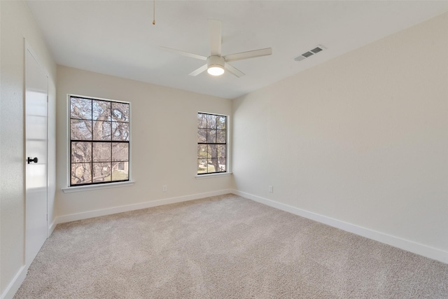 carpeted spare room with ceiling fan