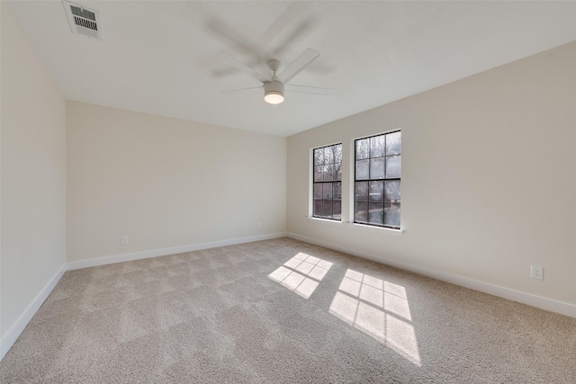 empty room featuring light colored carpet and ceiling fan