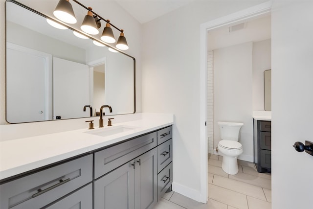 bathroom featuring tile patterned floors, toilet, and vanity