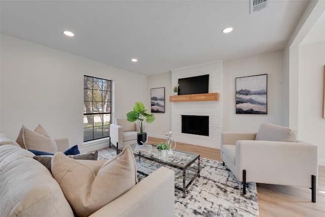 living room featuring a fireplace and light hardwood / wood-style flooring