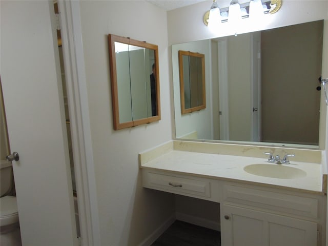 bathroom featuring vanity and toilet