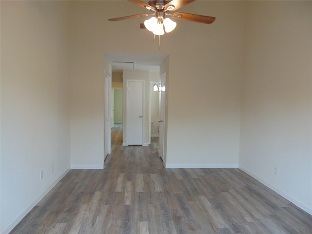 spare room with ceiling fan and light wood-type flooring