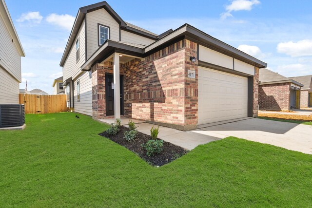 view of front of property featuring central AC, a garage, and a front lawn