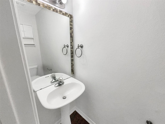 bathroom featuring sink and toilet