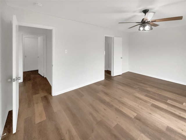 spare room featuring dark hardwood / wood-style floors and ceiling fan