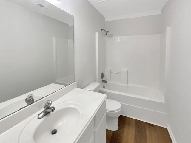 full bathroom with wood-type flooring, toilet, shower / bathing tub combination, and vanity