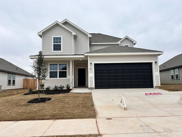 view of front of house with a garage and a front yard