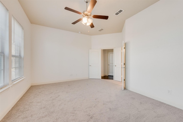 spare room featuring ceiling fan and carpet