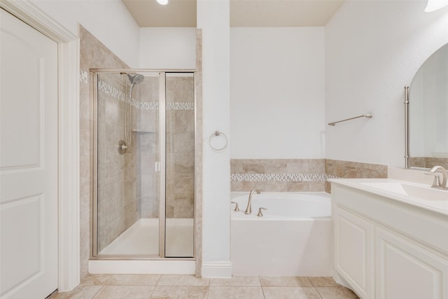 bathroom with tile patterned flooring, plus walk in shower, and vanity