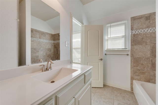 bathroom with lofted ceiling, vanity, and tile patterned floors