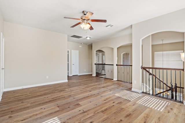 empty room featuring ceiling fan and light wood-type flooring