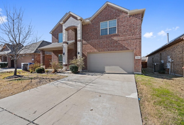 view of property with a garage, central AC, and a front lawn