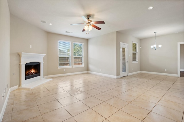 unfurnished living room featuring ceiling fan with notable chandelier and light tile patterned floors