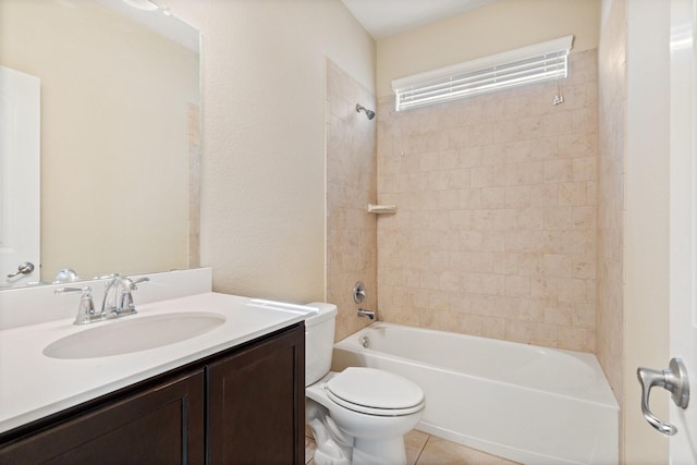 full bathroom featuring tiled shower / bath combo, vanity, tile patterned floors, and toilet