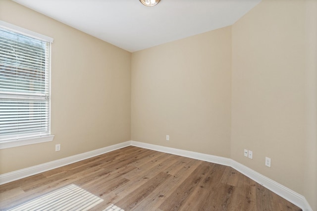 spare room with plenty of natural light and light hardwood / wood-style floors