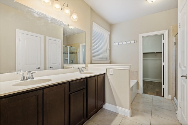 bathroom featuring vanity, separate shower and tub, and tile patterned floors