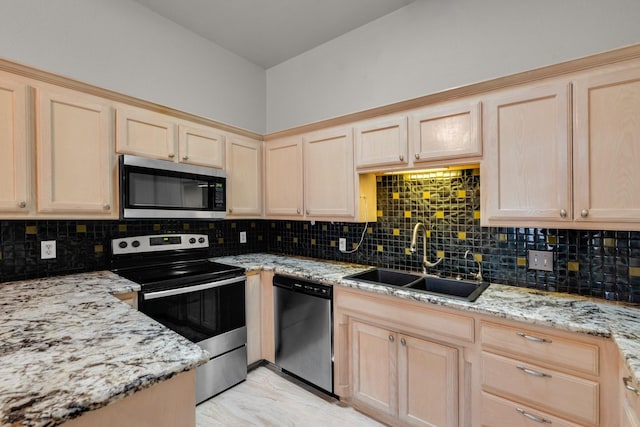 kitchen with tasteful backsplash, appliances with stainless steel finishes, sink, and light brown cabinets