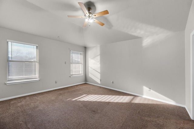 carpeted empty room with ceiling fan and lofted ceiling