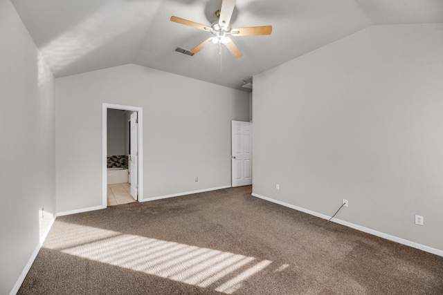 unfurnished bedroom with vaulted ceiling, light colored carpet, ceiling fan, and ensuite bath