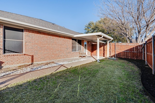 back of house featuring a yard and a patio area