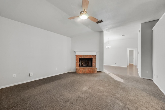 unfurnished living room with carpet floors, ceiling fan with notable chandelier, and a fireplace