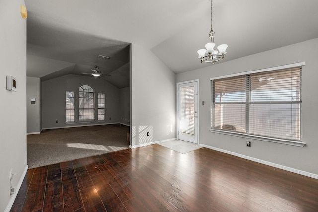 foyer featuring lofted ceiling, ceiling fan with notable chandelier, and wood-type flooring