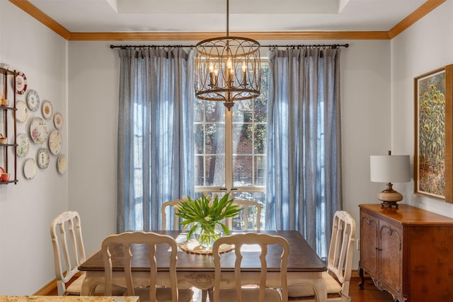 dining area featuring crown molding and a chandelier