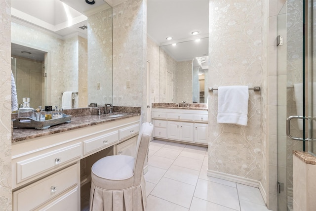 bathroom with tile patterned flooring, vanity, ornamental molding, and walk in shower