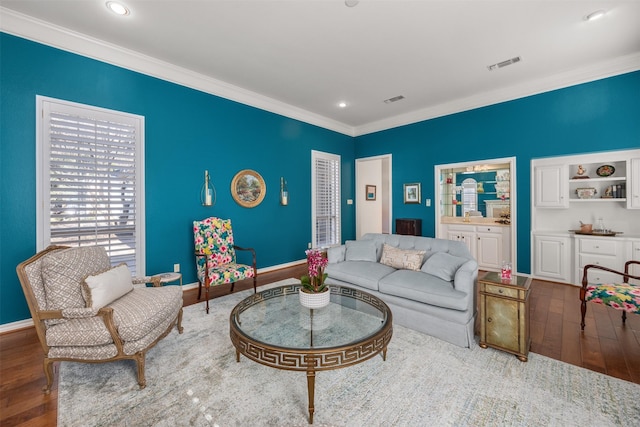 living room with crown molding and dark hardwood / wood-style flooring