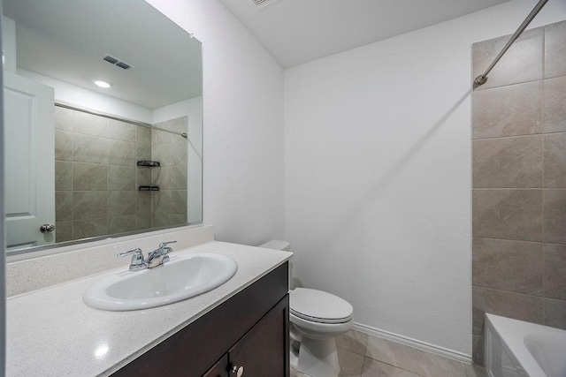 full bathroom with tile patterned flooring, vanity, tiled shower / bath combo, and toilet