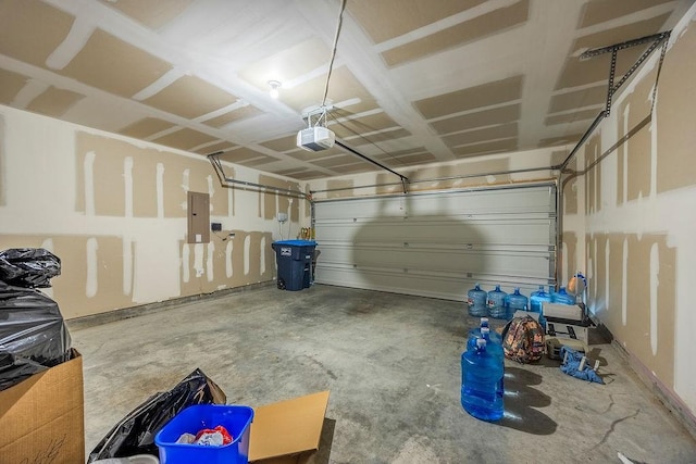 garage with a garage door opener and electric panel