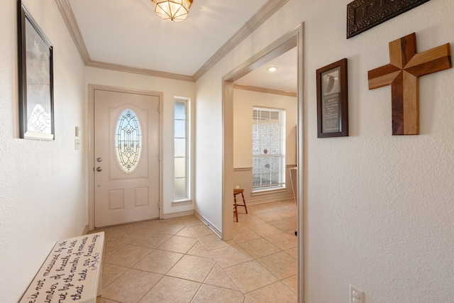 tiled entryway featuring crown molding