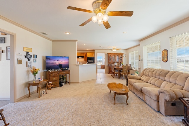 living room featuring crown molding, ceiling fan, and light carpet