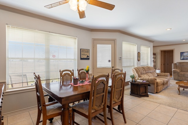 dining space with ornamental molding, light tile patterned floors, and ceiling fan