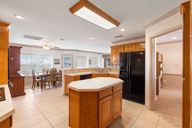 kitchen with sink, crown molding, kitchen peninsula, a kitchen island, and black appliances