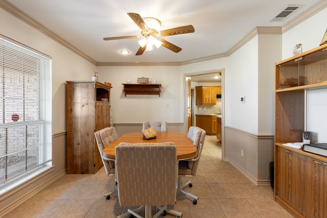 dining area featuring ornamental molding, light tile patterned floors, and ceiling fan