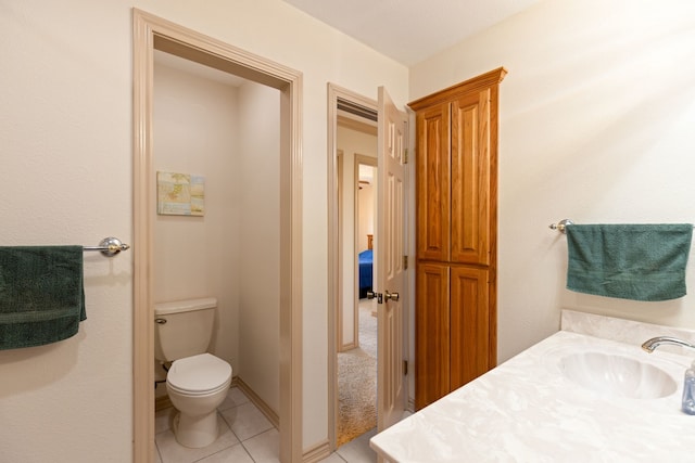 bathroom with vanity, tile patterned floors, and toilet