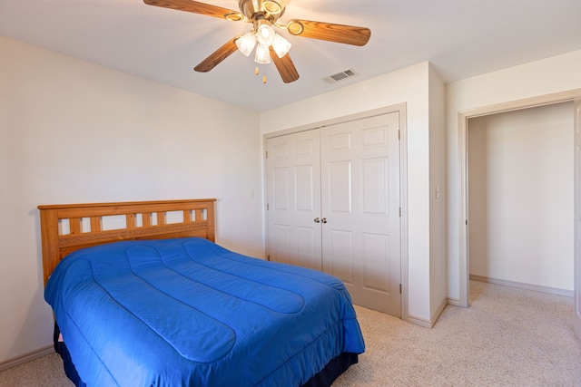 carpeted bedroom with a closet and ceiling fan