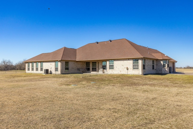 rear view of house with a yard